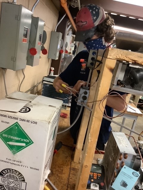 HVAC student wiring an a/c unit