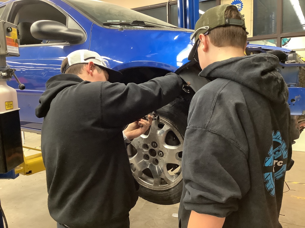 Auto tech team works and tie rods